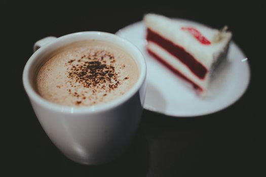 Vintage film look of cappuccino coffee and red velvet cake.