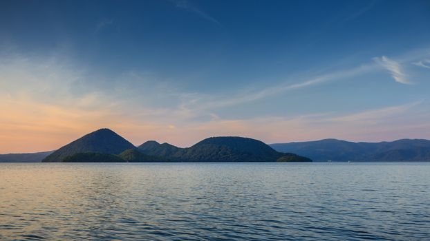 Scene of mountain and lake at twilight in Hokkaido, Japan.