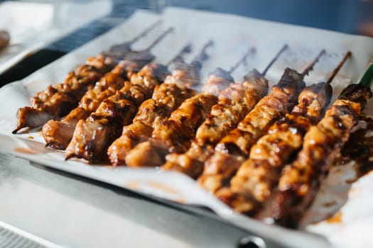 Roasted or grilled chicken on skewer or stick.