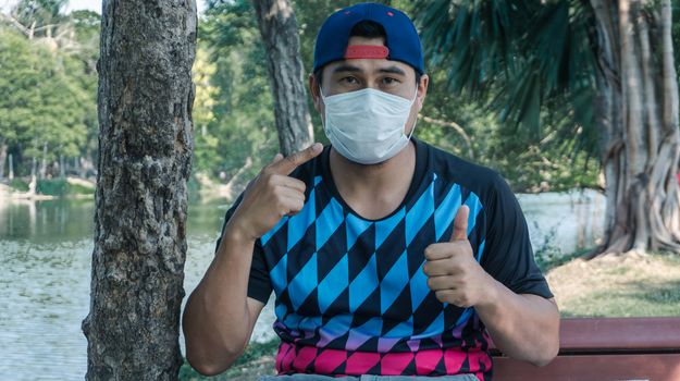 A young Asian man wearing a mask to prevent the spread of the virus. Men are unemployed due to a virus outbreak.