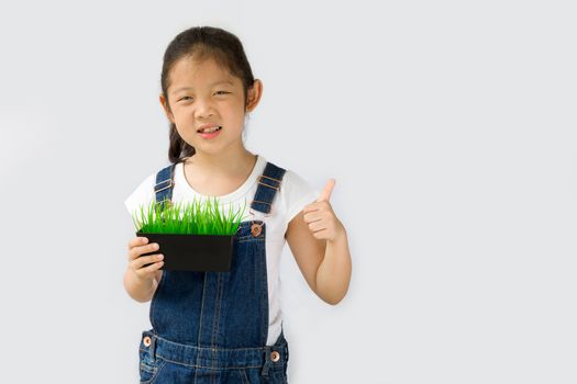 Studio shot of organic farming concept, Asian kid farmer, isolated on white background.