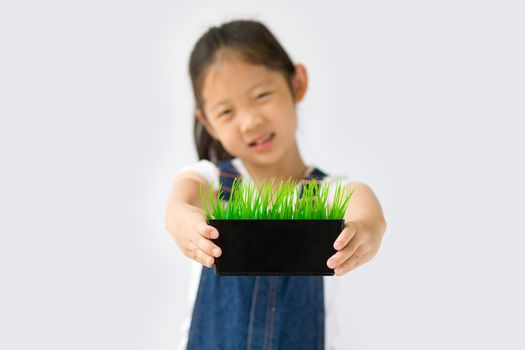 Studio shot of organic farming concept, Asian kid farmer, isolated on white background.