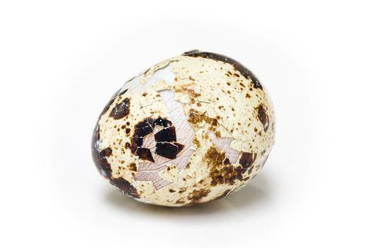 Studio shot of cracked quail egg isolated on white background.