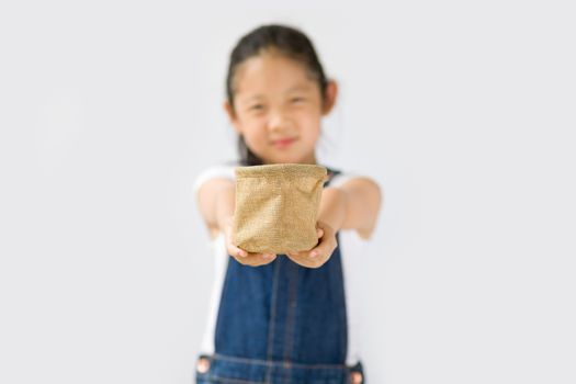 Studio shot of organic farming concept, Asian child farmer, isolated on white background.