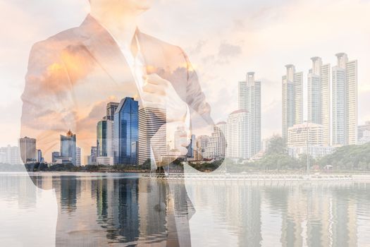 Business leadership concept shown by double exposure of businessman in suit with urban city background.