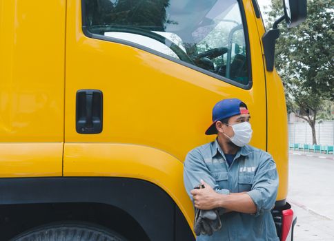 Close-up photos of Asian truck drivers wearing masks to protect against dust and the spread of the flu. Covid 19. Inside the car front