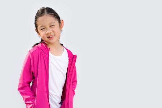Sporty concept illustrated by studio shot of Asian kid in sweater isolated on white background.