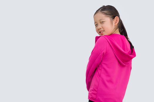 Sporty concept illustrated by studio shot of Asian kid in sweater isolated on white background.