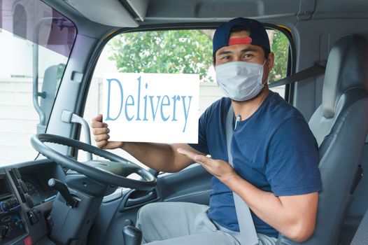 Close-up photos of Asian truck drivers wearing masks to prevent dust and the spread of flu. 19. Inside the car in front. He pointed his hand to suggest.