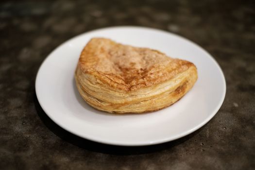 Baked apple puff turnover pastry in dish.