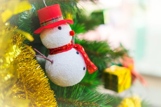 Snowman on a Christmas tree as decoration.