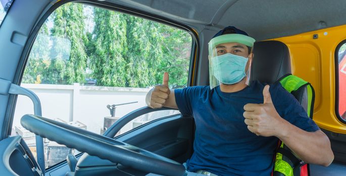 Close-up photos of Asian truck drivers wearing masks to protect against dust and the spread of the flu. Covid 19. Inside the car front