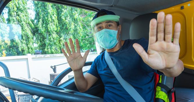 Close-up photos of Asian truck drivers wearing masks to protect against dust and the spread of the flu. Covid 19. Inside the car front