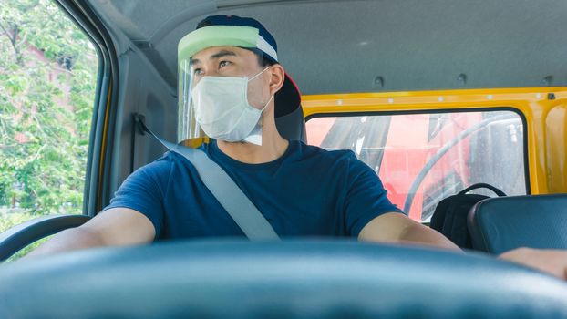 Close-up photos of Asian truck drivers wearing masks to protect against dust and the spread of the flu. Covid 19. Inside the car front