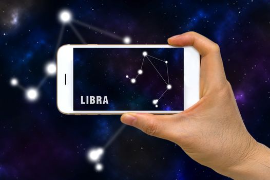 Concept of augmented reality, AR, of Libra zodiac constellation app on smartphone.
