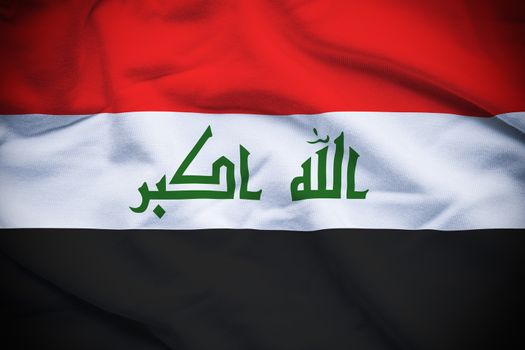 Wavy and rippled national flag of Iraq background.