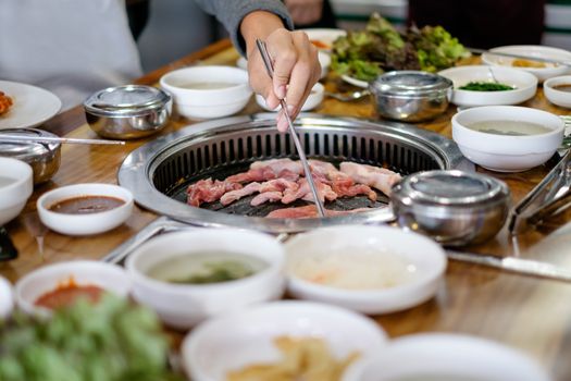Korean BBQ grilled pork and beef cooking.