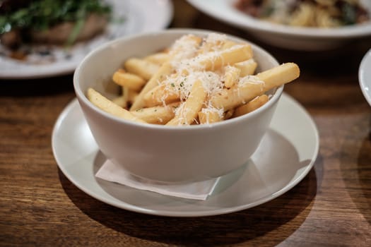 French fries with cheese on top.