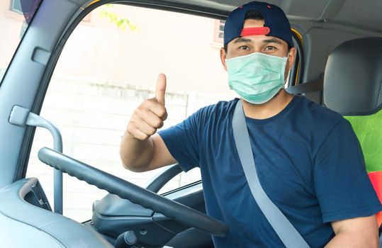 Close-up photos of Asian truck drivers wearing masks to protect against dust and the spread of the flu. Covid 19. Inside the car front