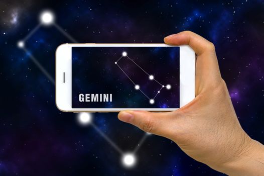 Concept of augmented reality, AR, of Gemini zodiac constellation app on smartphone.