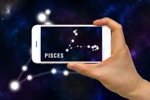 Concept of augmented reality, AR, of Pisces zodiac constellation app on smartphone.