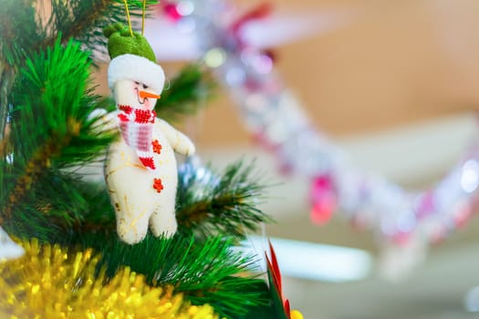 Snowman on a Christmas tree as decoration.