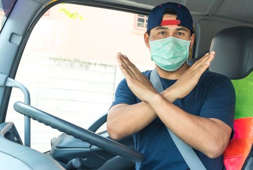 Close-up photos of Asian truck drivers wearing masks to protect against dust and the spread of the flu. Covid 19. Inside the car front