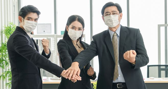 Stop Covid-19-Concept. A team of Asian businessmen wear masks to protect and prepare to fight the pandemic virus worldwide.