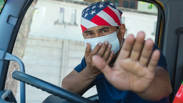 Close-up photos of Asian truck drivers wearing masks to protect against dust and the spread of the flu. Covid 19. Inside the car front