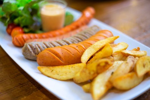 Dish of grilled sausage and French fries.