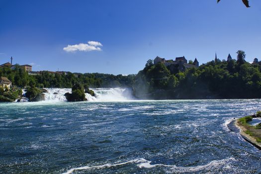 the famous rhine falls in the swiss near the city of Schaffhausen - sunny day and blue sky