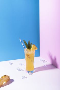 iced pineapple punch cocktail in glass on color background. summer drink.