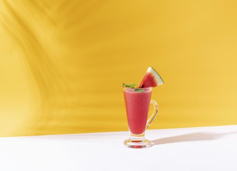 Fresh water melon juice and watermelon slice on color background. summer drink.