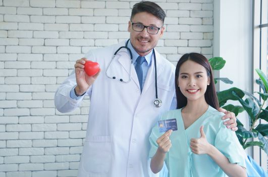 Photos of a male doctor taking care of a female patient and providing health care advice In the patient room of the hospital