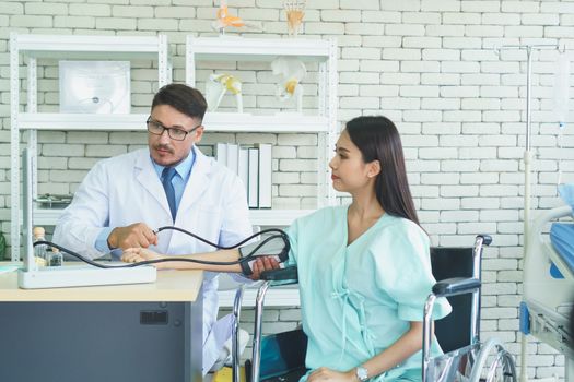 Photos of a male doctor taking care of a female patient and providing health care advice In the patient room of the hospital