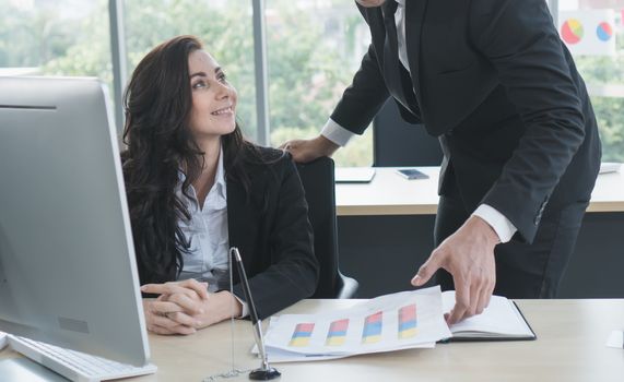 Caucasian business men and women working together happily at the office. They are meeting with a video call. To trade with business partners