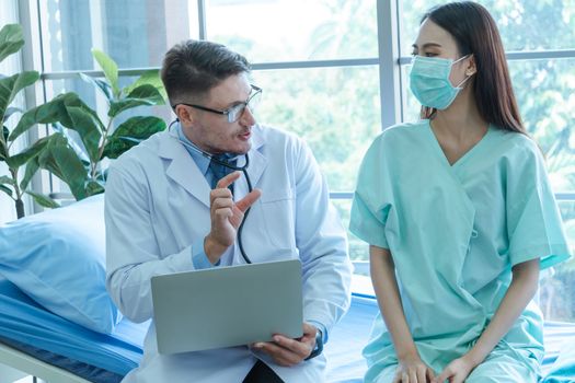 The doctors are checking the patients' symptoms closely. Asian female patients wear masks to prevent and stop the spread of the virus.