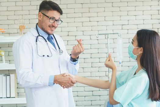 Photos of a male doctor taking care of a female patient and providing health care advice In the patient room of the hospital