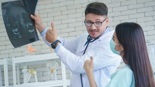 Photos of a male doctor taking care of a female patient and providing health care advice In the patient room of the hospital