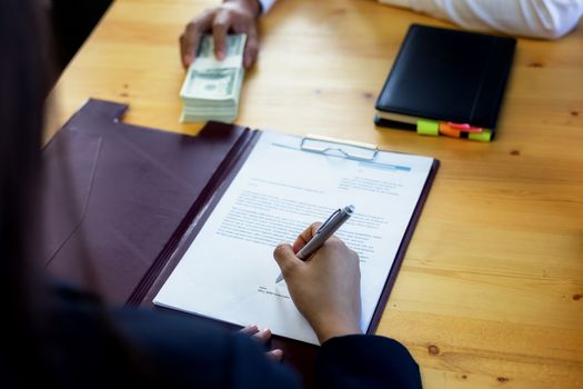 Business woman signing a loan for investment, negotiation