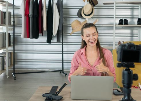 Beautiful Caucasian women are having fun and being happy at work. He is a product reviewer on YouTube.( Mock up books )