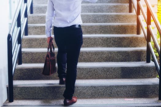 Portrait of a handsome young businessman who is negotiating a business on a mobile phone and negotiating a deal.