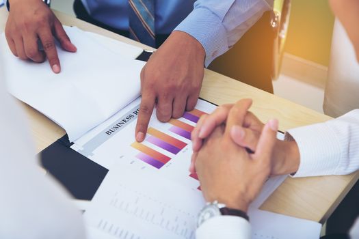 Portrait of investment agent consulting with his client while sitting at office