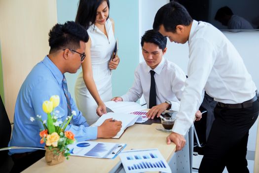 Portrait of investment agent consulting with his client while sitting at office