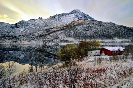 Lovely house on the bank of the mountain lake that looks like a pure nature mirror