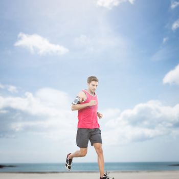 Fit man running against beach