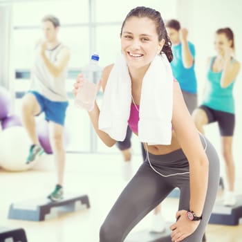 Composite image of fit woman with water