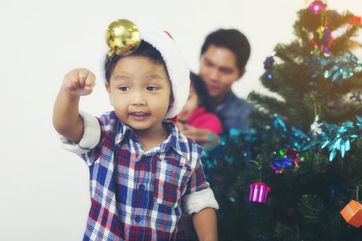 Father and son help to decorate the Christmas tree.