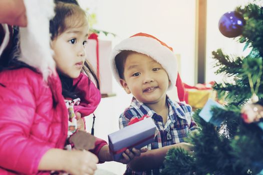 Father and son help to decorate the Christmas tree.