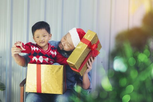 Dad opened a gift box with his son in a box.